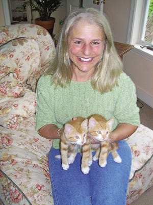 Betsy Coes of Newfields is the president of Cats 1st, a rescue organization that works with feral and abandoned cats and kittens. Coes is holding two kittens that are soon headed to new homes after being cared for by the group.