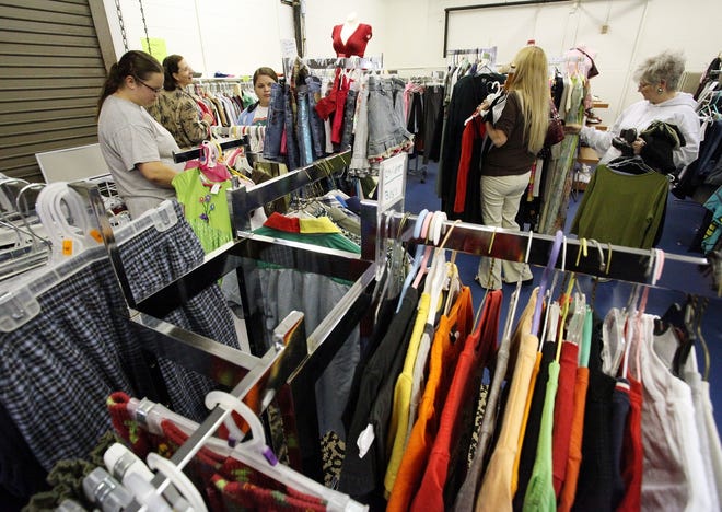 Patrons shop the Saints ShareWear thrift store in Building D, Room 121 on the Santa Fe College campus on Wednesday. The store is open Wednesdays only from 11:30 to 1:30 p.m. and is open only to students and employees of the college.