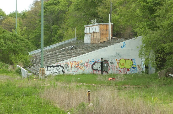 Legion Field’s dilapidated bleachers are covered with graffiti and surrounded by weeds.
