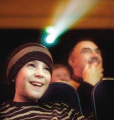 In this file photo from March 2007, Andrew Kirby of Exeter watches a film at the Ioka theater, now closed. A focus group met Tuesday, May 26, at the theater to discuss the future of the proposed Ioka Digital and Performing Arts Center which the new owners plan for the property.