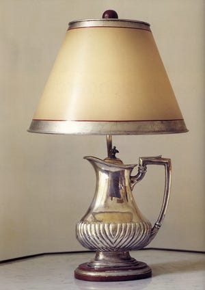 A favorite antique coffee pot has been wired and topped with a shade that's painted pearlescent white with a silver band.