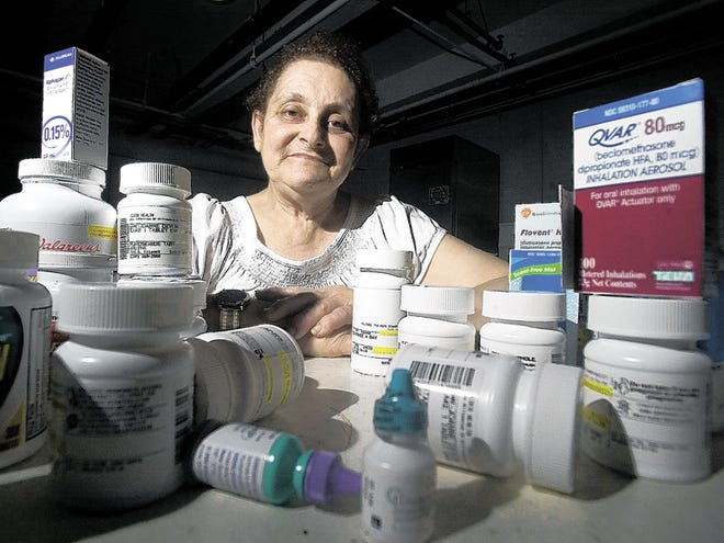 Joanne Devlin, from Pawtucket R.I., displays the prescription drugs she is currently taking, Thursday May 21, 2009. Devlin would be seriously affected by Rhode Island Gov. Don Carcieri's proposal to cut the state's prescription drug benefit for seniors and the disabled.