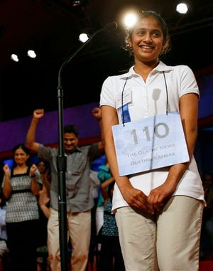 Kavya Shivashankar, 13, of Olathe, Kansas, wins the finals of the Scripps National Spelling Bee, in Washington, on Thursday, May 28, 2009. In the background her parents, Sandy Shivashankar, left, and Mirle Shivashankar celebrate.