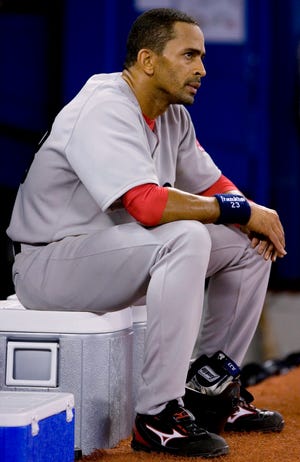 Boston Red Sox shortstop Julio Lugo sits in front of the Red Sox dugout during the ninth inning of their 6-3 loss to the Toronto Blue Jays.
