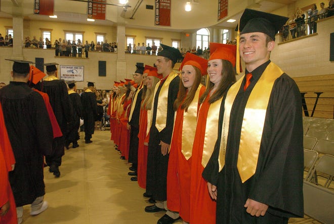 Graduates stand during the processional at Whitman-Hanson Regional High School's commencement, held Friday.