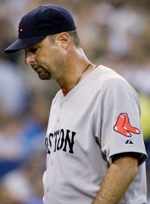 Boston Red Sox pitcher Tim Wakefield leaves the field following the end of the second inning of baseball game action against the Toronto Blue Jays in Toronto on Friday, May 29, 2009.