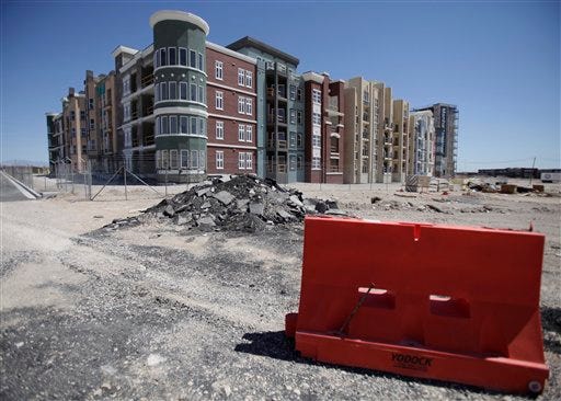 In this May 8, 2009 file photo, Manhattan West, a stalled condominium project, stands unfinished behind a fence in Las Vegas.