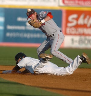NORWICH 5/30/2009
Connecticut's Brock Bond, bottom, slides safely onto second as Portland's Zach Borowiak, top, misses the ball in a baseball game at Dodd Stadium in Norwich Saturday, May 30, 2009. Bond went on to score the first run of the night.
Tali Greener/Norwich Bulletin
