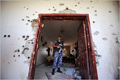 A Palestinian police officer examined the damage to a house after a clash between the Palestinian Authority and Hamas in the West Bank town of Qalqilya on Sunday.