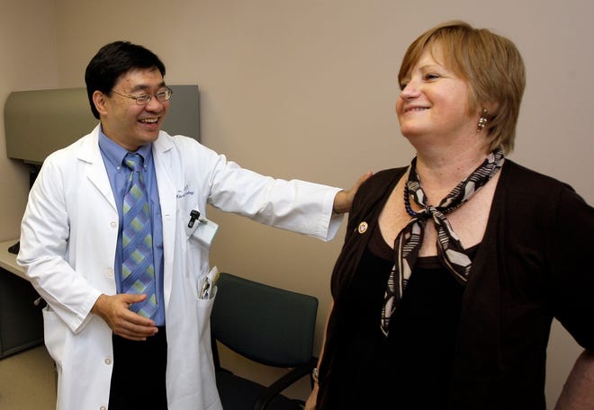 Dr. Patrick Hwu talks with patient Hilde Stapleton during an examination this month at a University of Texas medical center in Houston. Stapleton has been receiving an experimental melanoma treatment that trains the immune system to fight cancer.ASSOCIATED PRESS / DAVID J. PHILLIP