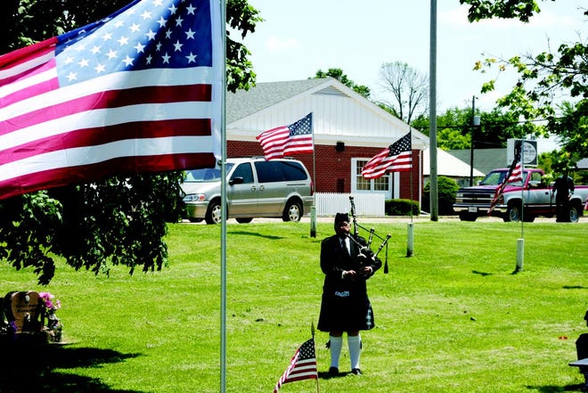 JUSTIN SIMS/DAILY REVIEW ATLAS
The bagpipes are played to start the traditional Memorial Day service at Little York Cemetery on Saturday afternoon. It was the first traditional Memorial Day observed in the community in 80 years.
