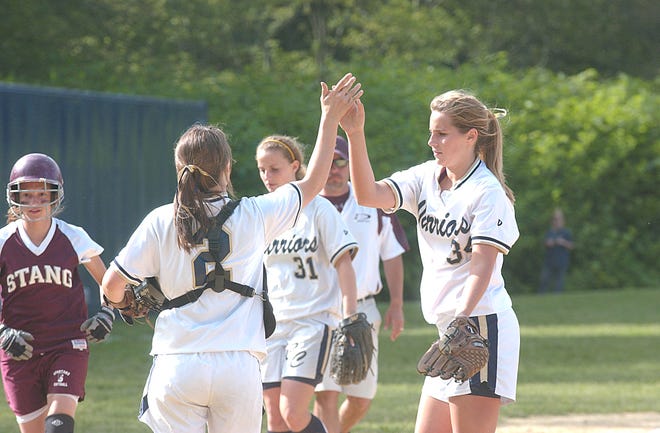 Coyle-Cassidy catcher Katie Bumila (2) congratulates Kathryn Bolduc after Bolduc recorded the third out in the fourth innning against Bishop Stang.