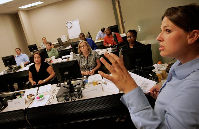 Andi Sager Gregorie, right, of Jacksonville, leads a property damage claims training workshop with recovery team members at the new Enterprise Rent-A-Car call center in Gainesville on Monday.