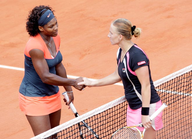 Russia's Svetlana Kuznetsova, right, shakes hands with U.S. player Serena Williams after a quarterfinal match of the French Open tennis tournament at the Roland Garros stadium in Paris, Wednesday June 3, 2009.