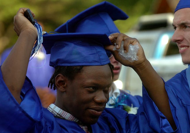 Quincy High Class of 2009 graduates: Kenneth McFadden puts on his cap.