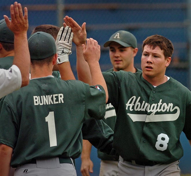 Abington's Ian Campbell (8) ischeered by teammates after scoring a run to give his team a 1-0 lead in first inning.