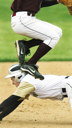 Galesburg High School's Mark Zhorne dives under a leaping Abrin Schaad of Peoria High School, as Zhorne steals second base in the first inning of Thursday's regional game played in Bartonville.