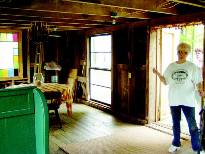 Owner Sherry Preston shows the interior of what was once a boat barn on the grounds of Preston's Antique Gaslight Village in Allen. Preston said they use this space as part of their annual Christmas activites.