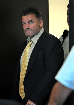 Scott Foxworth enters Middlesex Superior Court in Woburn after the morning break Tuesday. Foxworth, 55, is charged with shooting Framingham resident Ed Schiller in a Newton parking garage in January of 2006.