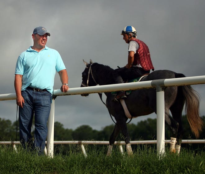 David Scanlon broke and trained three of the Belmont Stakes entrants this year. He is shown here timing horses on his track at the Robert Scanlon Training Center in Williston, about 30 miles northwest of Ocala.