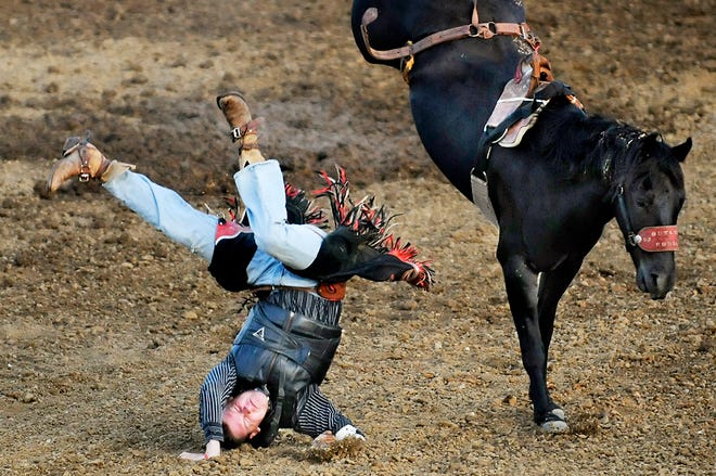 Shane Witherow tumbles from a horse during the bareback riding event of the inaugural Boonville Jaycees Rodeo on Friday at the Brady Show Grounds in Boonville.