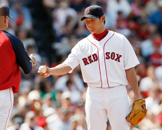 Red Sox starting pitcher Daisuke Matsuzaka hands the ball to manager Terry Francona after being removed from the game during the sixth inning of the Red Sox' 6-3 loss on Sunday at Fenway Park.