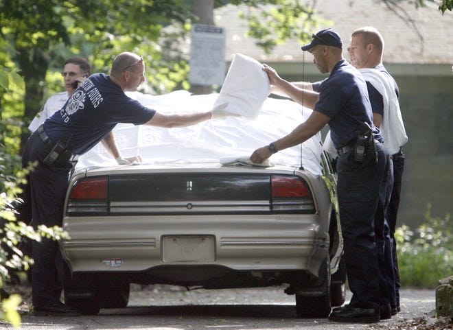 Members of the Canton Fire Department cover a vehicle with sheets. 35-year-old James Mammone III is in police custody for allegedly slitting the throats of his children — ages 3 and 5. Stark County Coroner P.S. Murthy said the children were killed in a vehicle at an apartment complex on Fulton Road NW.