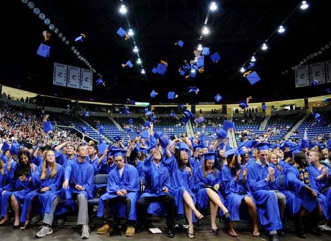 Graduates throw their mortarboards at the close of Lexington High School's commencement exercises Sunday.