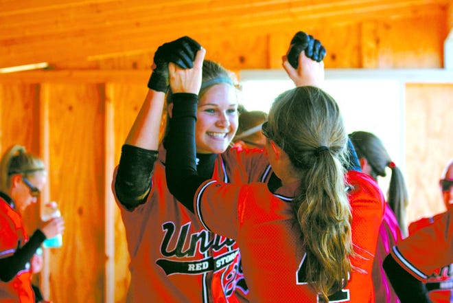 Gina Long and Megan Patterson celebrate the Red Storm's first run against Dakota in supersectional play.