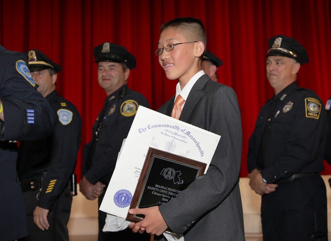 Bryan Huynh receives a Citizens Safety Award from the Massachusetts Safety Officers League for helping thwart a home invasion. After hearing robbers in his Weymouth home, he used a cell phone to make a 911 call.