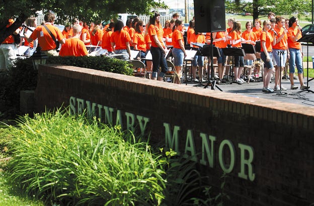 Members of the Church of the Resurrection Youth Orchestra and Hand Bells perform just outside Seminary Manor Friday morning. The group, on tour, included a stop in Galesburg where they played for residents of Seminary Manor and Hawthorne Inn.