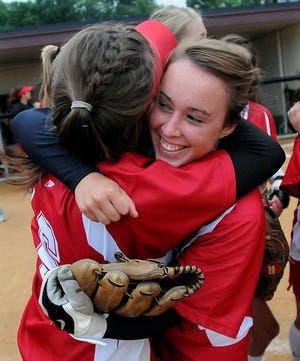 Hudson's Kayley Fannon, right, hugs pitcher Nikki Meuse after the Hawks' win over Hampshire in a Division 2 girls softball semifinal at UMass Thursday night.