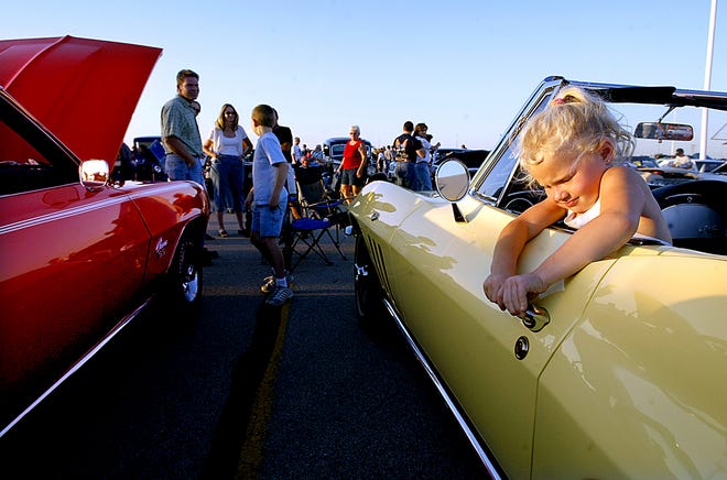 File/The State Journal-Register 
Six-year-old Kayden Brust of Pawnee tries to open the door of a 1965 Corvette, owned by family friend Mike Brownlow, at the Mid-West Charity Cruise in 2004. The show has been canceled this year.
