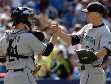 Florida Marlins pitcher Matt Lindstrom, right, and catcher John Baker celebrate their 6-5 victory Saturday over the Toronto Blue Jays in an interleague baseball game in Toronto on Saturday.