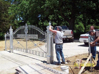 Submitted photo
Midstate Manufacturing employees erect a new metal gate at Brookside Cemetery on Linwood Road.