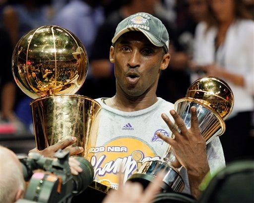 Kobe Bryant poses with the MVP trophy and Larry O'Brian trophy after the Lakers beat the Magic in Game 5 of the NBA Finals on Sunday night.