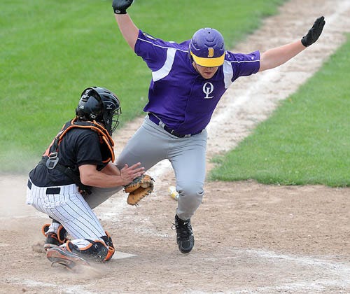 Dave Manley / The Journal-Standard
Freeport catcher Isaiah Almasy tags out Orangeville's Jason Brinkmeier at home during the American Legion game in Freeport on Tuesday.