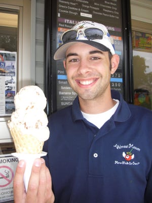 Matt Truax of Almost Heaven hoists a waffle cone of homemade butter pecan ice cream.