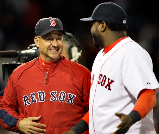 Boston Red Sox manager Terry Francona, left, celebrates with David Ortiz after the Sox defeated the Forida Marlins 6-1.