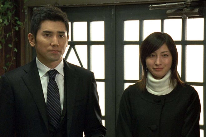 From left, Motoki as Daigo Kobayashi and Ryoko Hirosue as Mika Kobayashi in "Departures."
