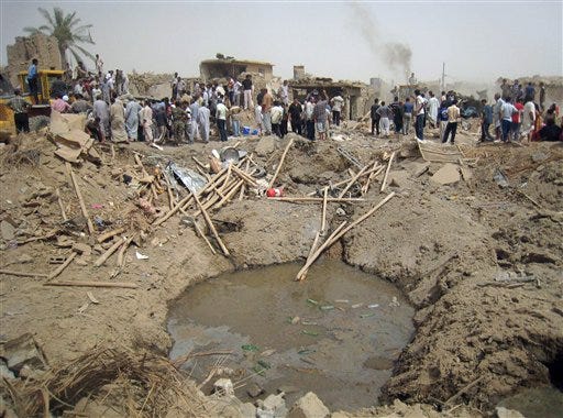 The crater left behind by a truck bombing is seen near Kirkuk, 290 kilometers (180 miles) north of Baghdad, Iraq, Saturday, June 20, 2009. Brig. Gen. Sarhat Qader says Saturday's explosion occurred following noon prayers south of the disputed city.
