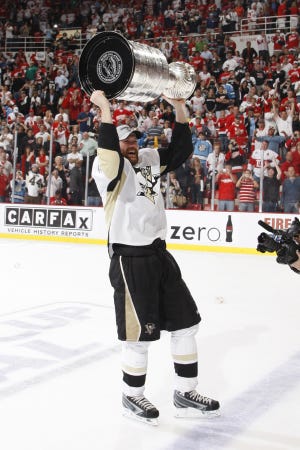 Bolton native Hal Gill holds the Stanley Cup aloft after the Penguins won the NHL's title over the Red Wings.