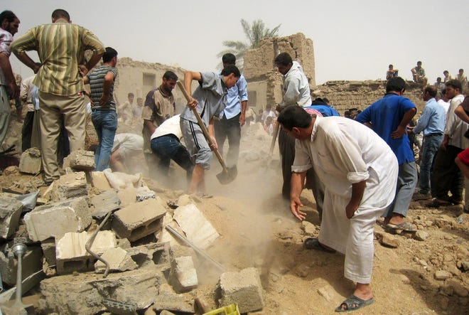 Men search for survivors buried in rubble after a truck bombing Saturday near Kirkuk, Iraq. ASSOCIATED PRESS / EMAD MATTI