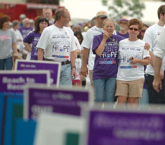 PLAINFIELD 6/20/2009
Cancer survivor Veronica Krodel of Plainfield, center, holds on to her daughter Joann Graser, right, also of Plainfield, as she becomes emotional while participating in the survivor's walk to kick of the Plainfield Relay for Life event Saturday, June 20, 2009. Krodel's husband, Joe, left, walks with beside her.
Tali Greener/Norwich Bulletin