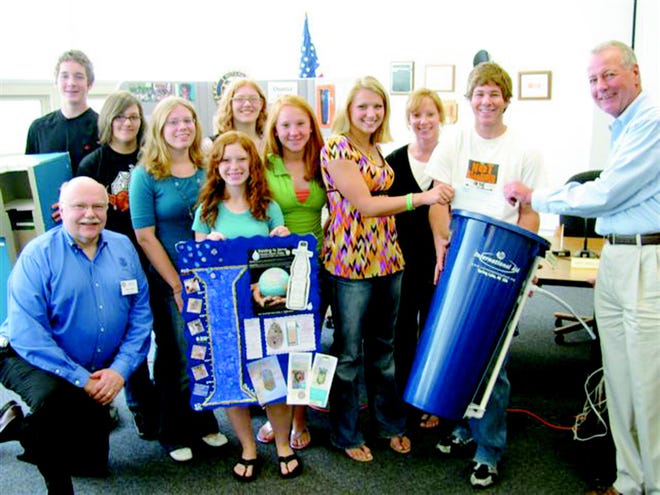 Members of the Jonesville Interact Club and their advisor and Rotarian Principal Chellie Broesamle and representatives from the Rotary District 6360 stand with a water filter. The Interact Club raised $600 that they donated for the purchase of 10 BioSand Water Filters that will provide safe drinking water for families in the Dominican Republic.