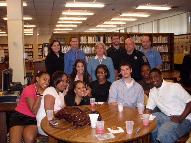 Film Trial Picture 
Standing in the back, from left, are advisers
 Donna Riordan, Jeffrey Driscoll, Patricia Downey, Eric Dresser, Officer Al Gazerro and Mark Linde. Front row, from left, are students Solange Goncalves, Amaccius Johnson, Michaela McGee, Alexandra Corbin-May, Janae Perkins, Daniel Cowell, Patrick Jolicoeur and Carlito Weaver.