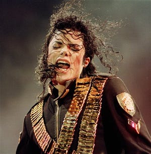 FILE - In this Aug. 29, 1993 file photo, pop singer Michael Jackson performs during his "Dangerous" concert in National Stadium, Singapore. (AP Photo/C.F. Tham, file)