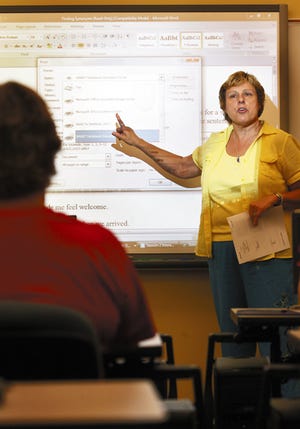 Instructor Jean Tulin explains the workings of a SMART Board to a class she was teaching at Carl Sandburg College's Cyber Camp.