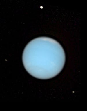 Neptune, natural color view, with three of its moons, Proteus (top), Larissa (lower right) and Despina (left), from Hubble space telescope