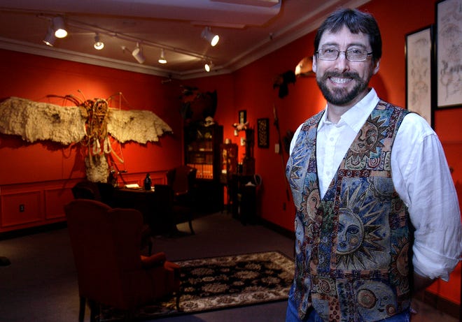 Artist Hilary Scott stands inside the Higgins Armory Museum in Worcester with his "Beyond Belief" exhibit.